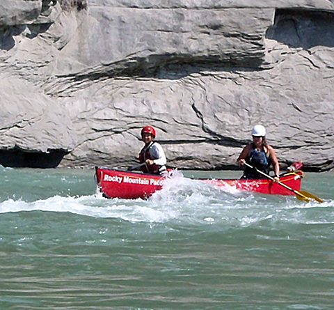 Two particiapnts paddling whitewater canoe 480x445