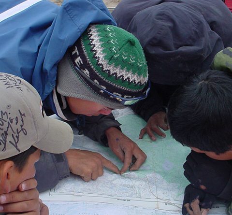 group-of-indigenous-boys-reading-map
