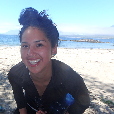indigenous youth smiling on beach west coast