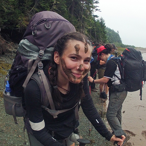 smiling_backpacker_with_mud_on_her_face
