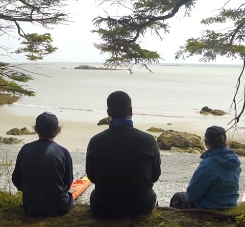 three indigenous youth looking out at Bay of Fundy 480x445