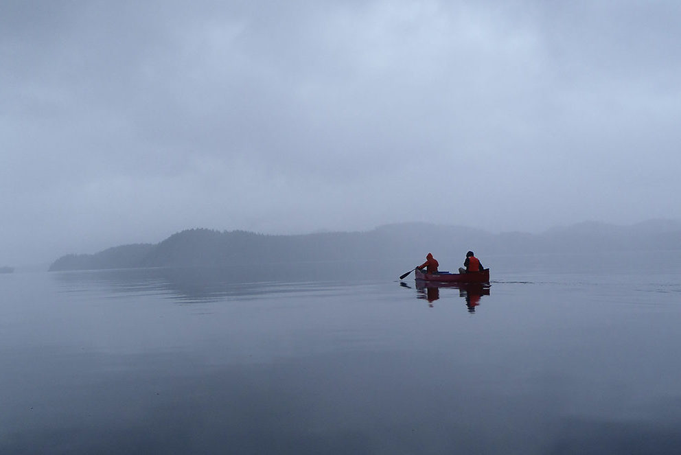 canoers on foggy lake