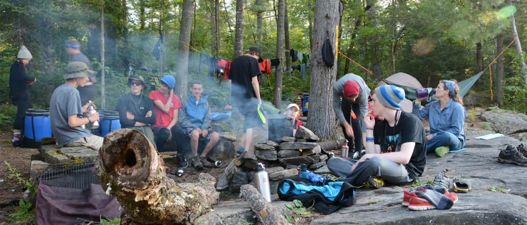 Image of a group of people doing different chores in the forest