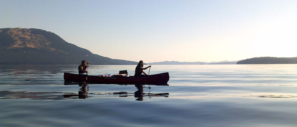 two people canoeing on the west coast at sunset
