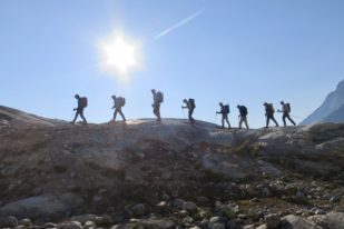 A line of mountaineers on a mountain ridgeline