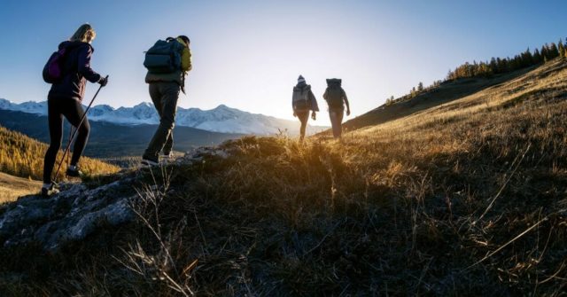 Hikers in mountains at sunset