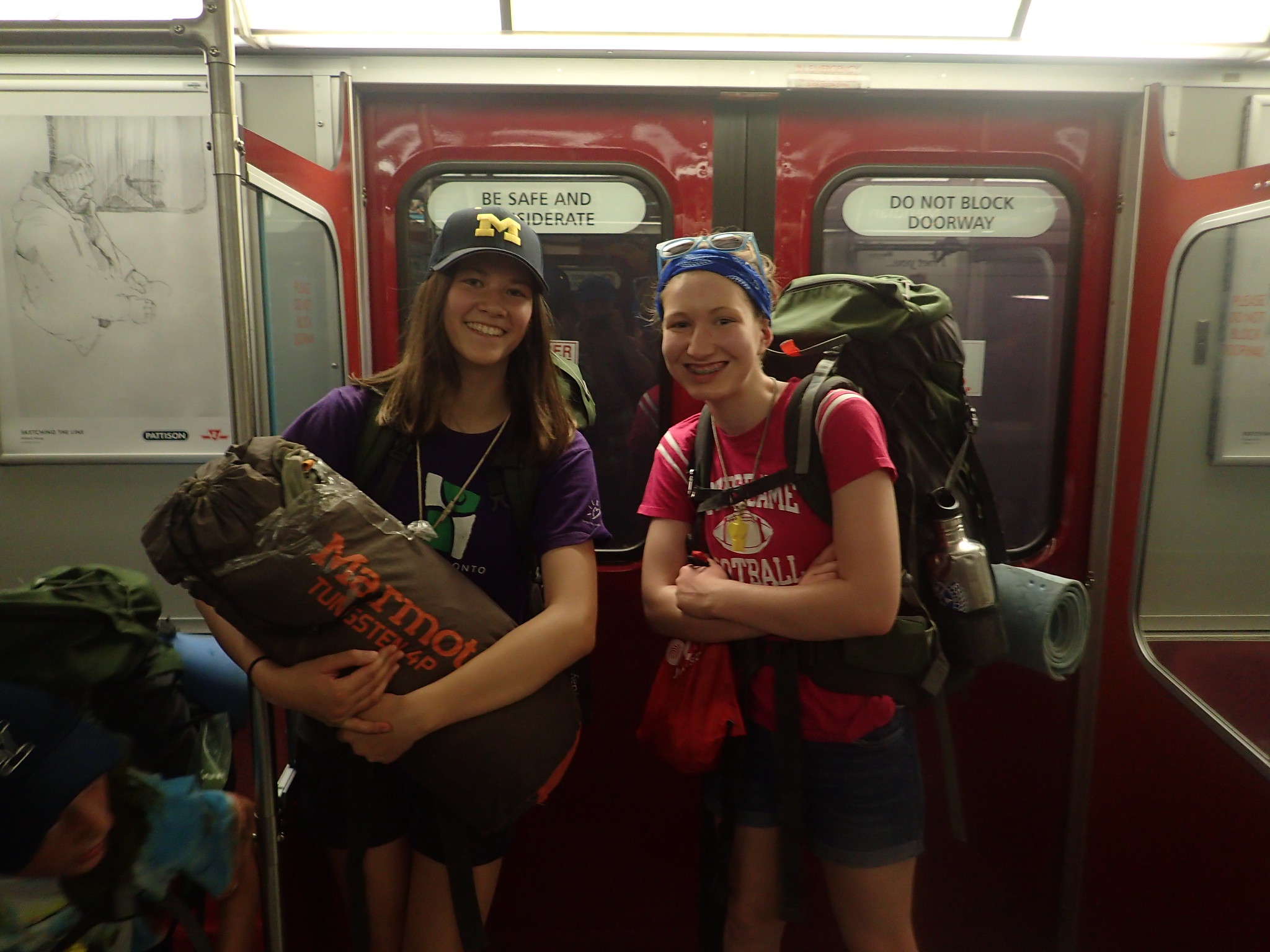 two teens standing with camp gear on the TTC