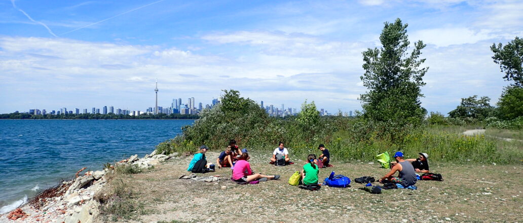 Teens sitting on Toronto island in a circle