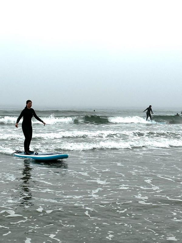 teens surfing in west coast water